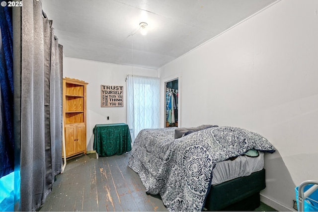 bedroom featuring dark hardwood / wood-style floors and a closet