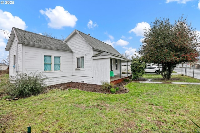 view of side of home with a lawn