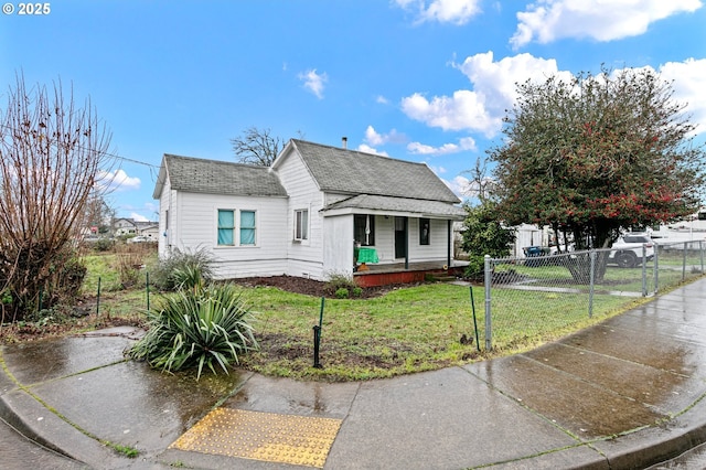 bungalow-style home featuring covered porch and a front lawn