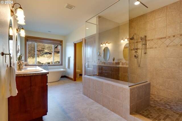 full bathroom with vanity, toilet, and independent shower and bath