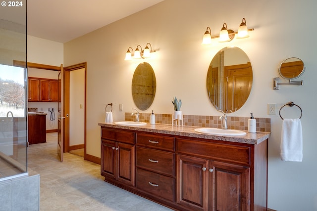 bathroom featuring baseboards, double vanity, a sink, and decorative backsplash