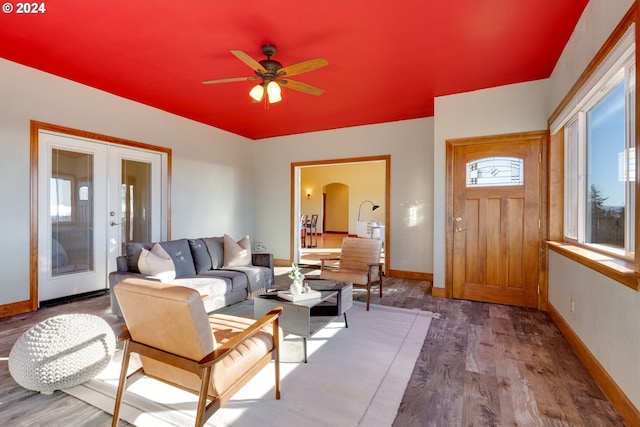 living area with ceiling fan, french doors, wood finished floors, and baseboards