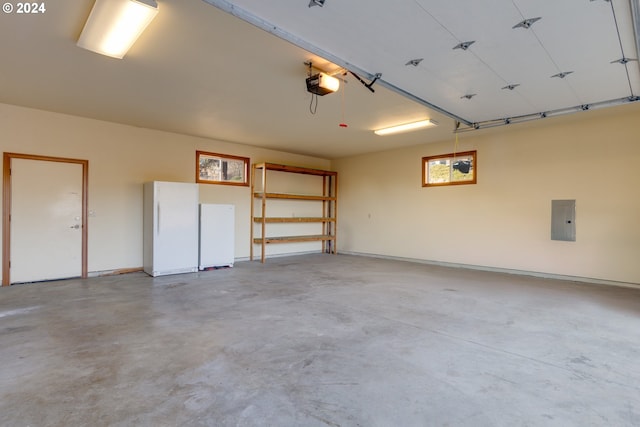 garage with electric panel and a garage door opener