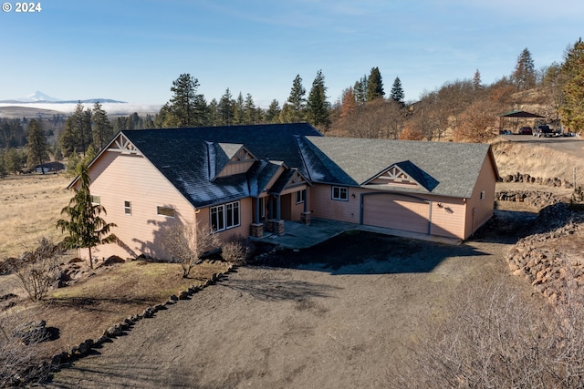 view of front of house featuring driveway, an attached garage, and a mountain view