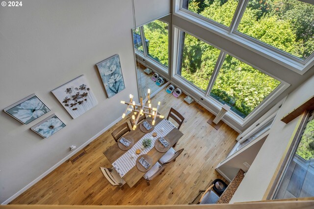 living room with an inviting chandelier and a towering ceiling