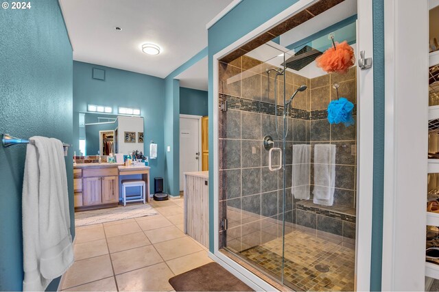 bathroom featuring vanity, walk in shower, and tile patterned floors