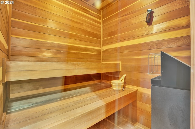 view of sauna featuring wooden walls