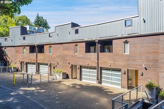 rear view of house featuring a garage