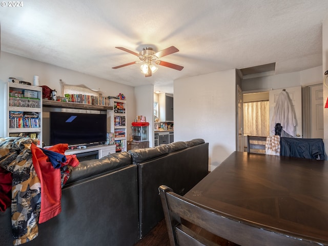 living room with a textured ceiling and ceiling fan