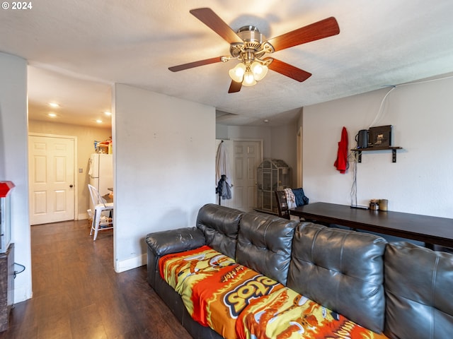 living room featuring wood-type flooring and ceiling fan