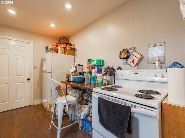 kitchen with dark hardwood / wood-style flooring and white appliances