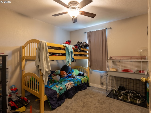 bedroom featuring ceiling fan and carpet