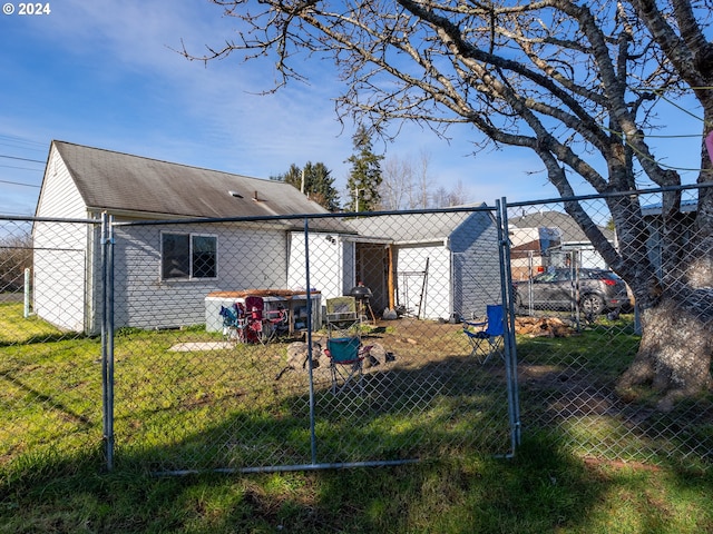 rear view of property featuring a lawn