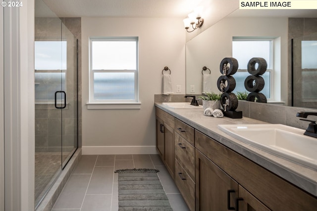 bathroom featuring tile patterned flooring, vanity, and an enclosed shower