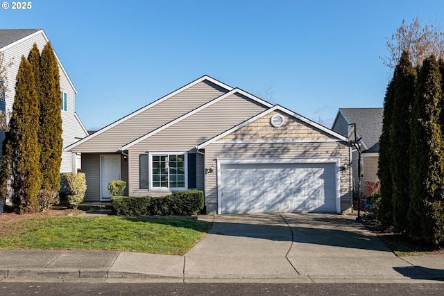 view of front of property with a garage and a front lawn