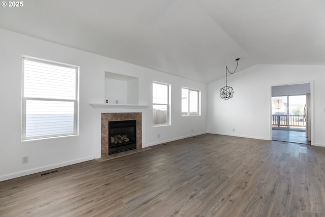 unfurnished living room featuring hardwood / wood-style floors, a fireplace, and vaulted ceiling