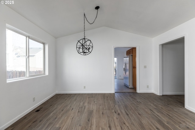 interior space featuring vaulted ceiling, dark hardwood / wood-style floors, and a chandelier