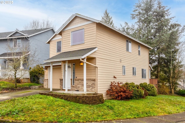 view of front of property featuring a front yard and a garage