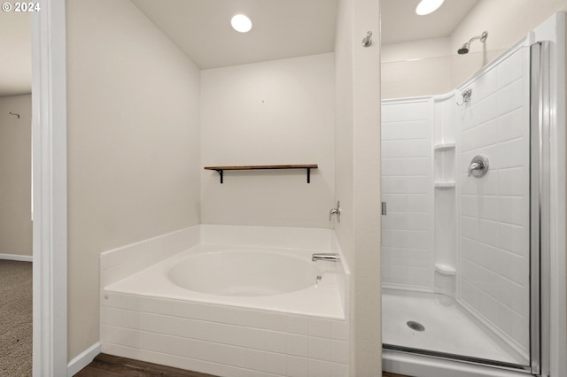 bathroom featuring separate shower and tub