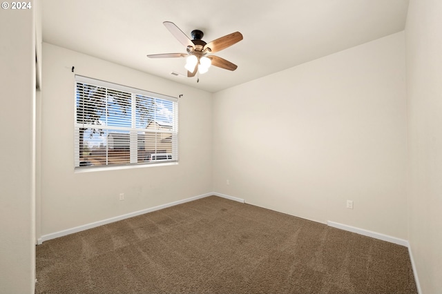 spare room featuring ceiling fan and carpet floors