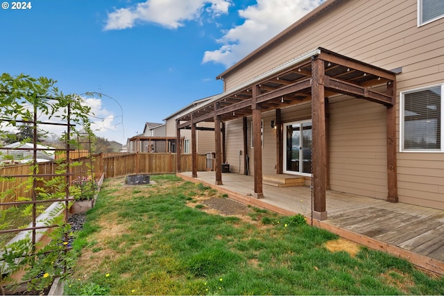 view of yard featuring a wooden deck and an outdoor fire pit