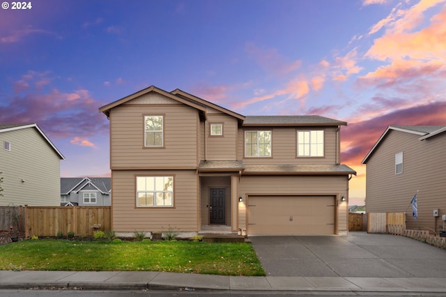 view of front of property with a lawn and a garage