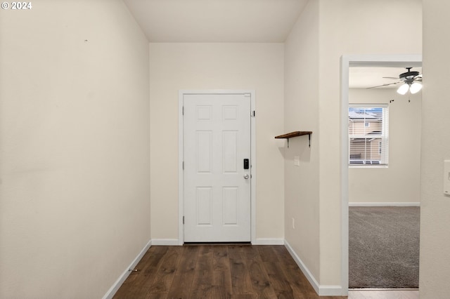 interior space featuring dark wood-type flooring and ceiling fan