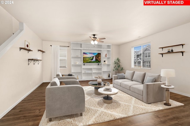 living room featuring ceiling fan and dark hardwood / wood-style flooring