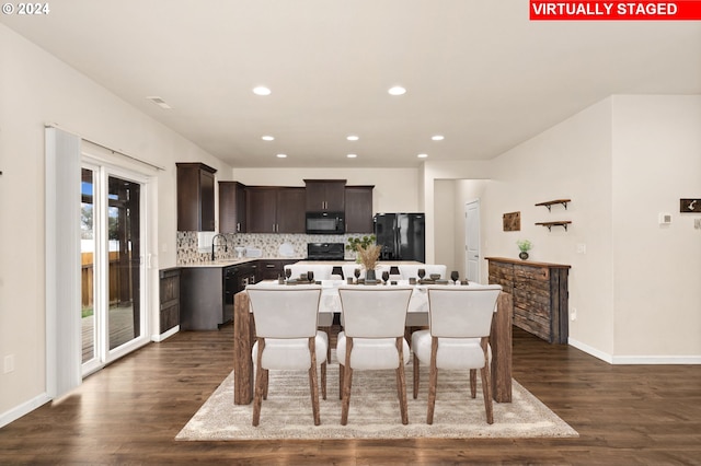 dining space with dark wood-type flooring and sink