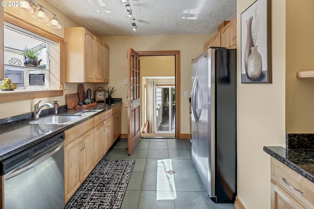 3329 SE Steele St, Portland, OR 97202 - kitchen featuring stainless steel appliances, light brown cabinets, healthy amount of natural light, and a textured ceiling