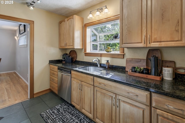 3329 SE Steele St, Portland, OR 97202 - kitchen featuring stainless steel dishwasher, light brown cabinetry, dark tile patterned flooring, and dark stone counters