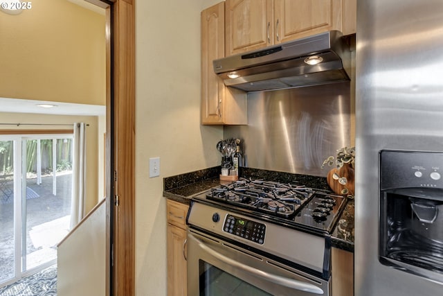 3329 SE Steele St, Portland, OR 97202 - kitchen featuring appliances with stainless steel finishes, under cabinet range hood, light brown cabinets, and dark stone counters