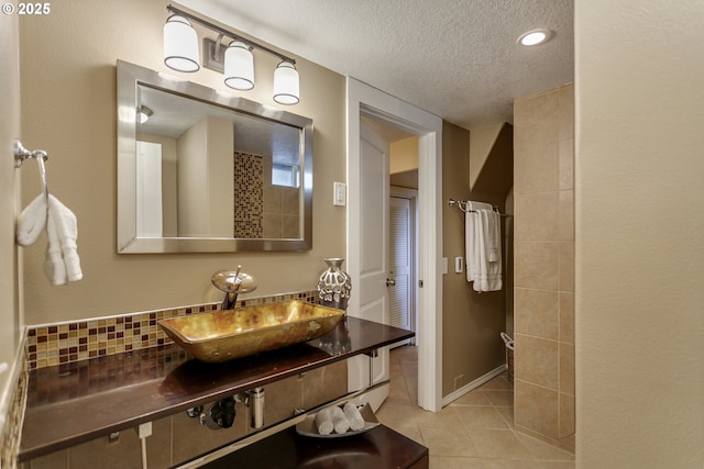 3329 SE Steele St, Portland, OR 97202 - bathroom featuring a textured ceiling, tile patterned floors, vanity, and backsplash