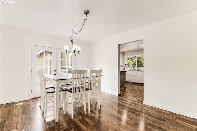 dining room featuring dark hardwood / wood-style floors and an inviting chandelier