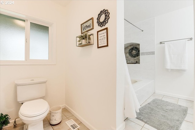 bathroom with tile patterned floors, toilet, and shower / tub combo with curtain