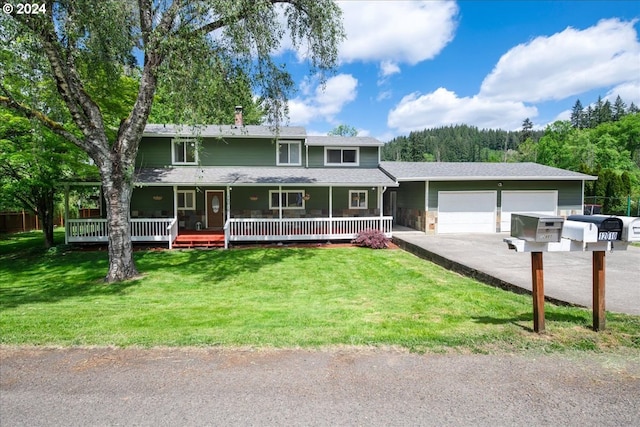 view of front of house with a porch, a garage, and a front lawn