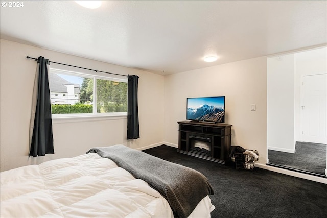 carpeted bedroom with a fireplace