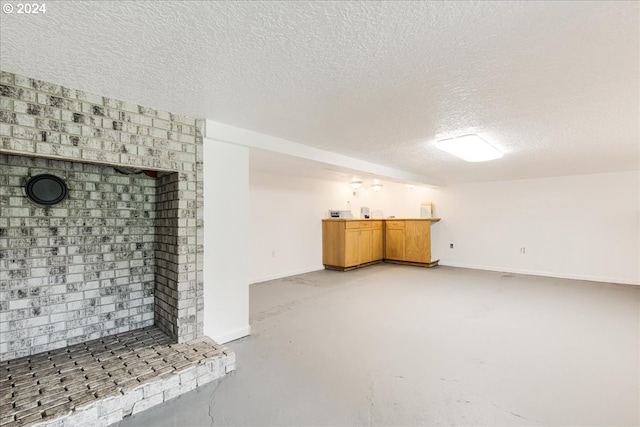 unfurnished living room featuring concrete flooring and a textured ceiling