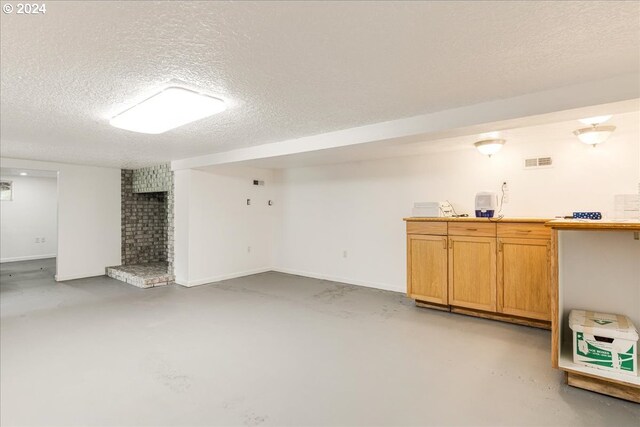 basement featuring a textured ceiling