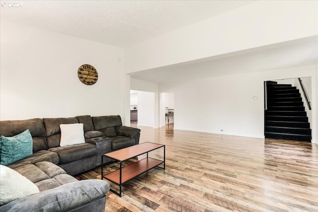 living room with a textured ceiling and hardwood / wood-style flooring