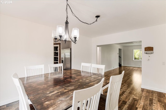 dining area featuring a chandelier and dark hardwood / wood-style floors