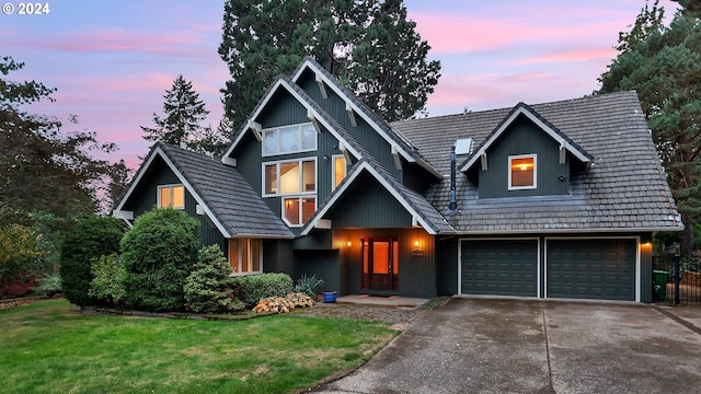 view of front of house with a garage and a lawn