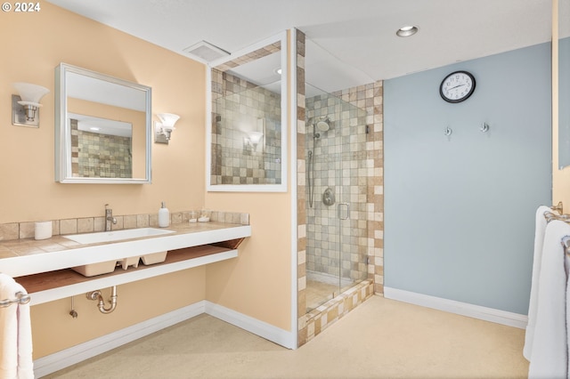 bathroom featuring a shower with door and vanity