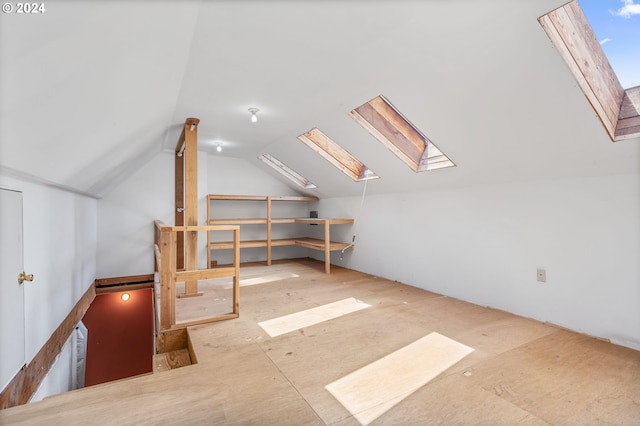 bonus room with vaulted ceiling with skylight