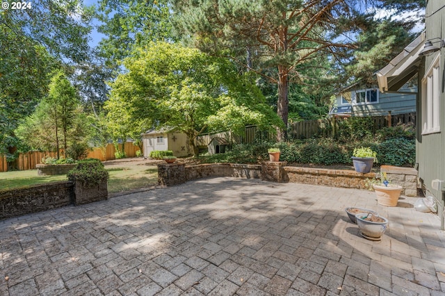 view of patio / terrace with a shed and a fire pit