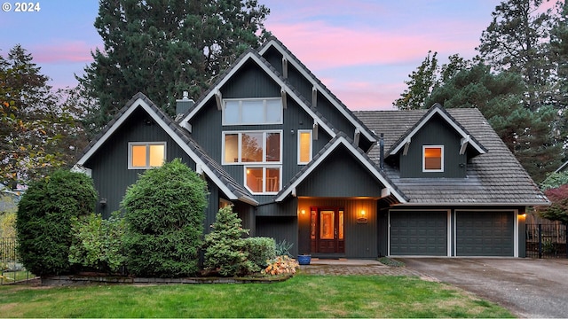 view of front of house with a yard and a garage