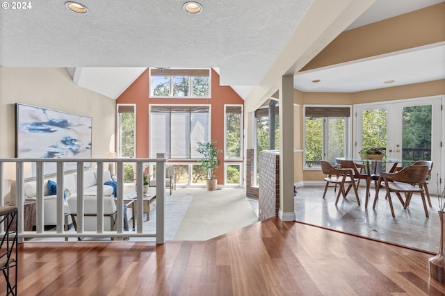 interior space with french doors, hardwood / wood-style flooring, and plenty of natural light