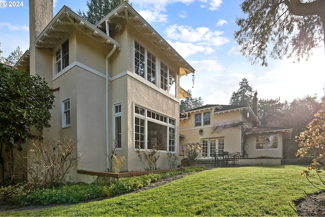 back of house with a pergola and a yard