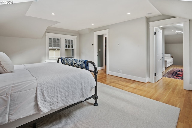 bedroom with lofted ceiling and hardwood / wood-style floors