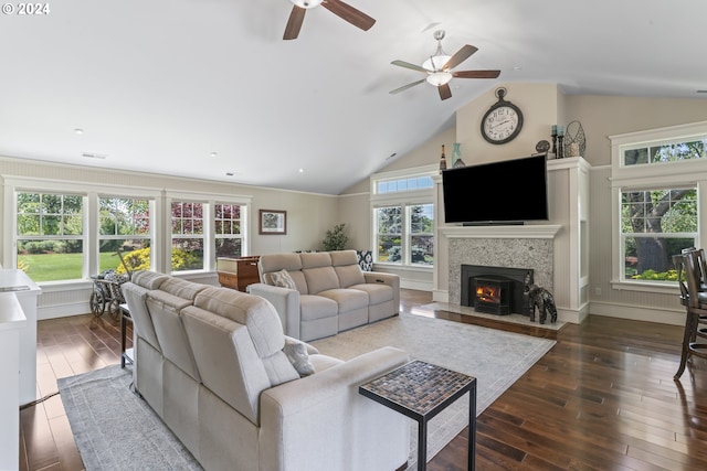 living room featuring lofted ceiling, dark wood-type flooring, and plenty of natural light